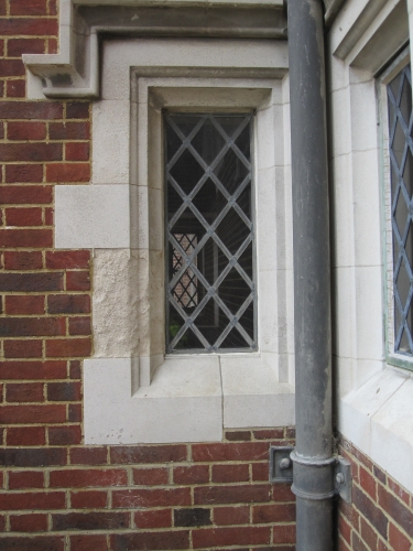 Weathered Portland stone corner window